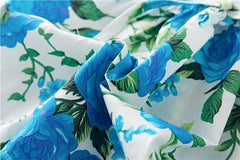 Bomullskjole med blomstertrykk og rysjer